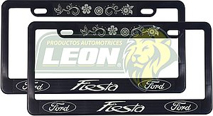 PORTAPLACAS NEGRAS GRABADAS FORD FIESTA / FLORES LETRAS FLUORESCENTES (JGO. c/2 pzas.)
